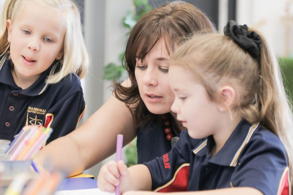 Teacher helping student