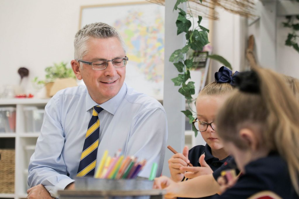 Principal with students in Early Learning Centre
