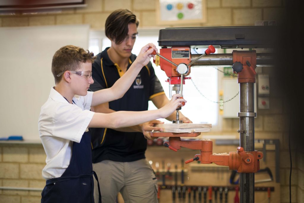 Student using machinery in wood work